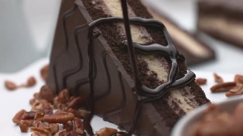 Chocolate Cake Slice Being Drizzled with Chocolate
