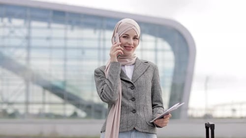 Young Woman Talking on Phone near Airport