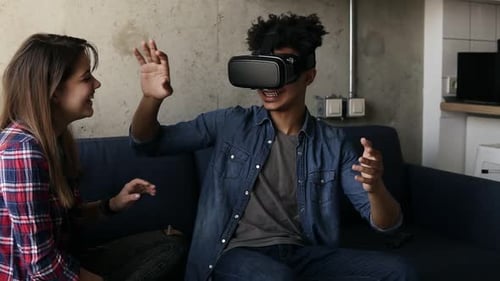 Man Experiences Virtual Reality Headset With Friend