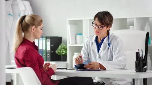 Professional Female Medic Consultation Young Woman Looking at Xray Image Surrounded By Hospital