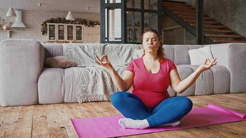 Woman Meditating on Yoga Mat at Home