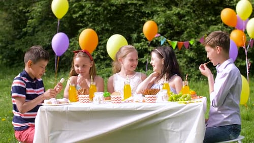 Happy Kids on Birthday Party at Summer Garden
