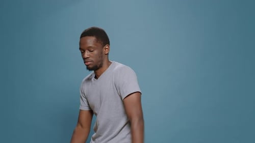 Enthusiastic Man Dancing and Smiling in Studio