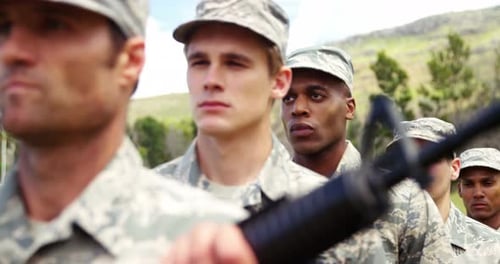 Serious Military Personnel Standing at Attention Outdoors