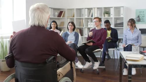 Diverse Group Listens to Presentation in Office
