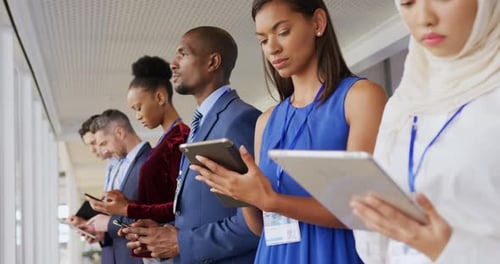 Business Professionals with Mobile Devices at Convention