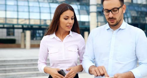 Business People Talking and Using Mobile Technology