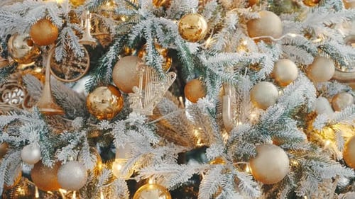 Golden Christmas Tree Ornaments and Twinkling Lights