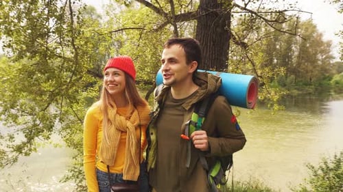 Active Young Couple of Tourists Enjoying the View Looking at the Mountain Forest Landscape, Travel