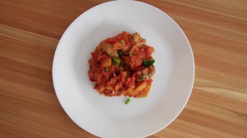 Sprinkling Scallions on Potatoes with Red Sauce