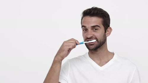 Smiling Man Brushing Teeth