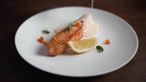 Plated Salmon Fillet with Lemon and Creamy Sauce