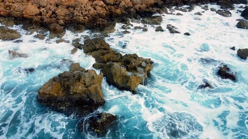 Flying Over Ocean Coastline Cliffside with Blue Pure Water Sea Waves Washes the Rocky Shore Above