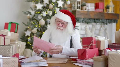 Santa Claus Reading Letters Surrounded by Christmas Gifts