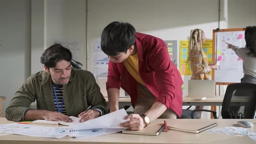 Businessman creative designers present work to the team.Designers a meeting in a modern office.