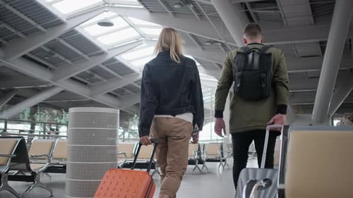 Airport Passengers Rolling Their Luggage