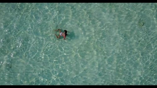 One girl enjoys life on relaxing shore beach vacation by blue ocean with white sand background of th