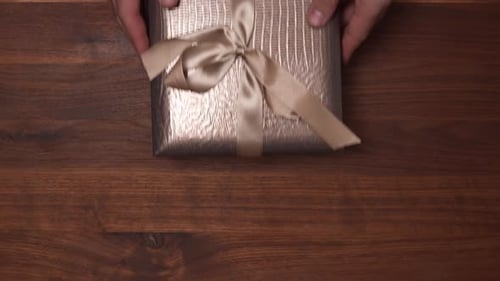 Wrapped Gift Placed on Wooden Table