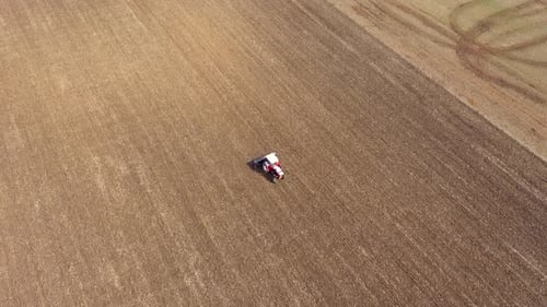 Flying Above a Tractor Plowing the Field