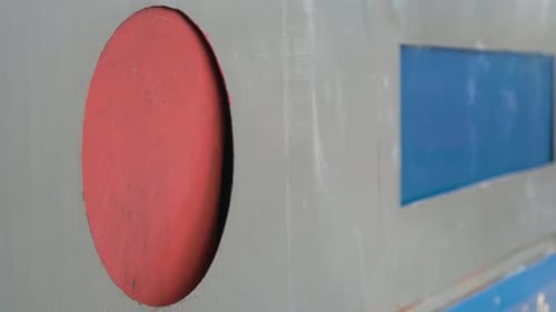 Hand Recycling Bottles into Container Close Up