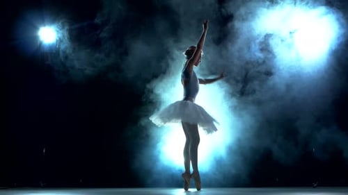 Elegant Ballerina Dancing Gracefully on Stage in Spotlights