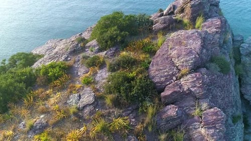 Aerial Top View of Cliff Rocks in a Blue Ocean