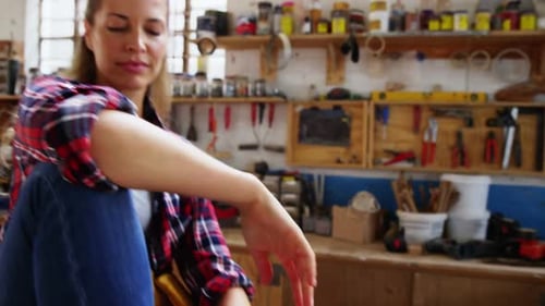 Woman Smiles in Woodworking Shop