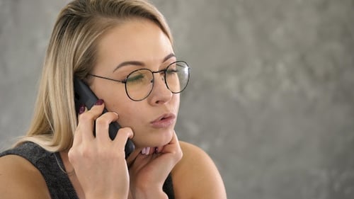 Woman Talking on Phone in Workplace Close Up