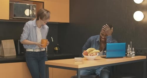 Friends Chatting in a Modern Kitchen