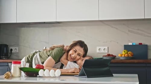 Mother and Daughter Embrace in a Bright Kitchen