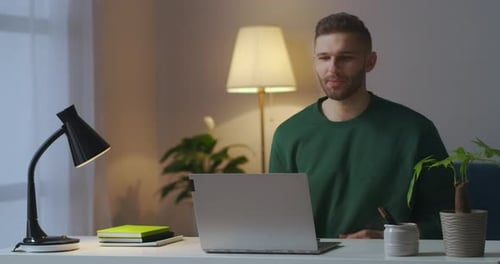 Man Working From Home and Video Chatting