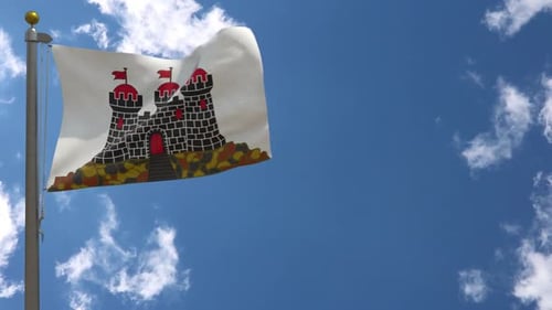 Waving Flag with Castle Emblem Against Blue Sky