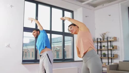 Happy Couple Exercising at Home