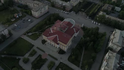 Aerial view of beautiful house of culture square and alley. People walk, cars drive on roads 11