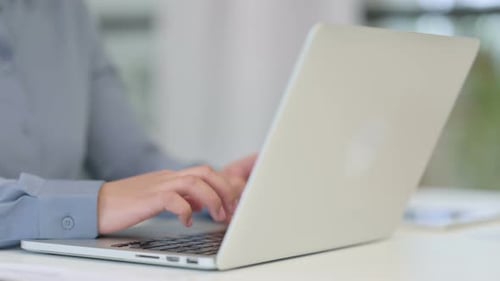 Close Up of African Woman Typing on Laptop