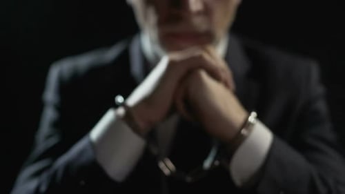 Angry Criminal Imprisoned in Handcuffs, Unfair Businessman Punished for Offense
