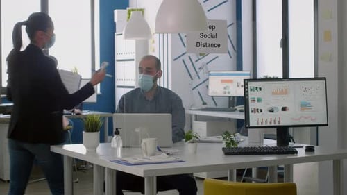 Employees in Face Masks Working at Desks