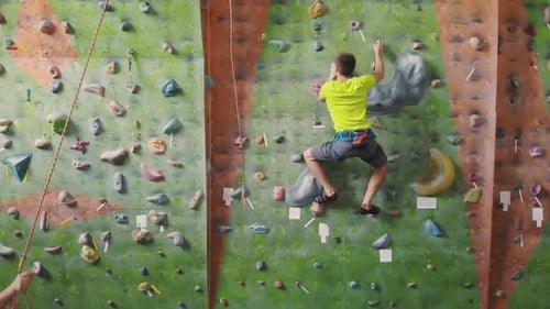 Young Adult Climbing Indoor Rock Wall for Exercise
