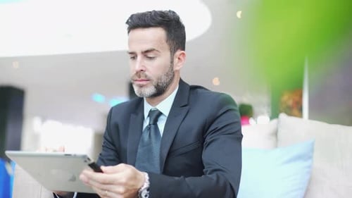 Professional Man Using Tablet Device Indoors