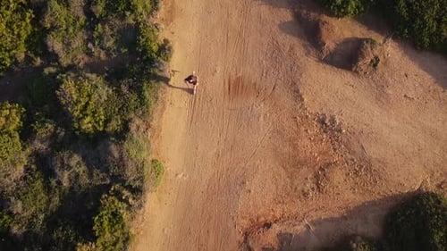 Person Walking on Dirt Road Aerial Shot