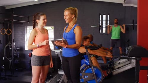 Trainer and Young Adult Client in a Gym