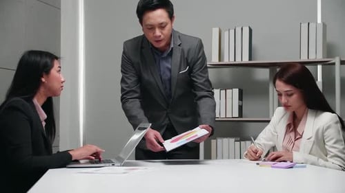 Business Team Discussing Data in Modern Office