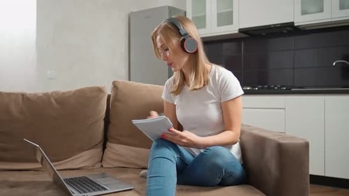 Young Woman Studying at Home with Laptop