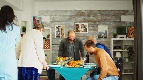Family Gathering around the Table for Festive Meal