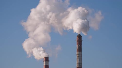 Industrial Smoke Stacks Against a Blue Sky