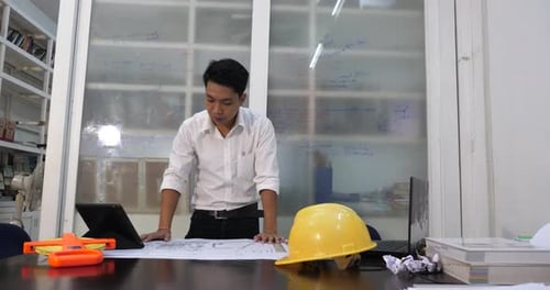 Architect Plans Building Project at Office Desk