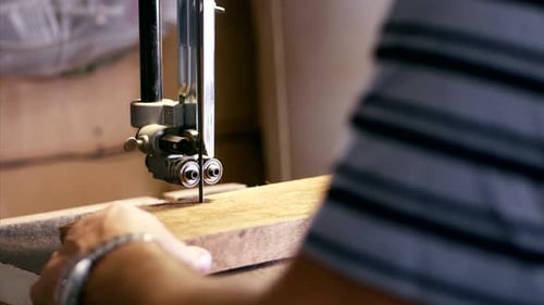 Wood Piece Being Guided Through Bandsaw Close Up