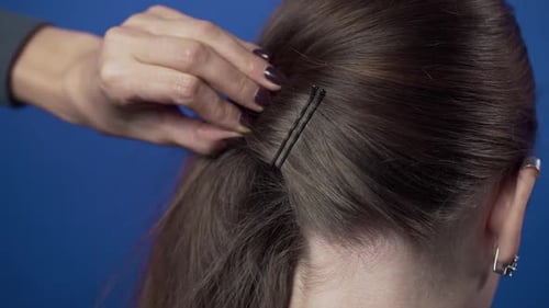 Stylist Puts Bobby Pins in Brown Hair