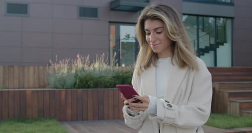 Successful Bussiness Lady Using Smartphone While Standing at City Street. Crop View of Stylish Young