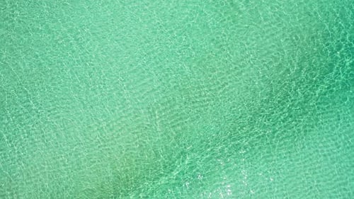 Wide birds eye abstract shot of a white sandy paradise beach and blue ocean background